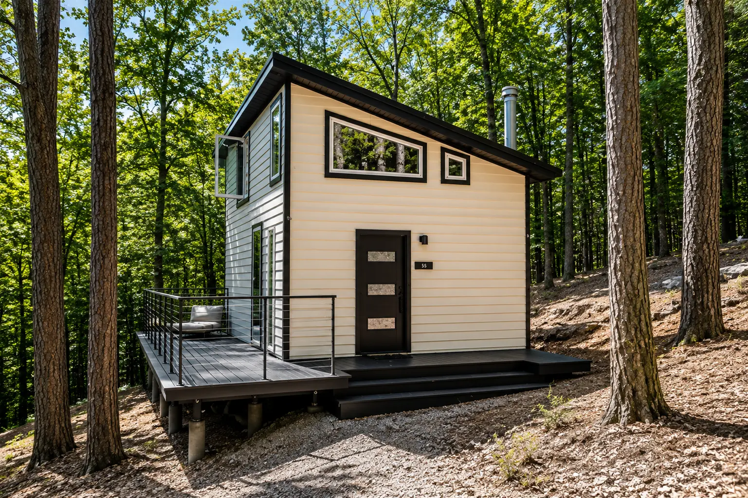 Cabin perched on the wooded hillside with deck seating